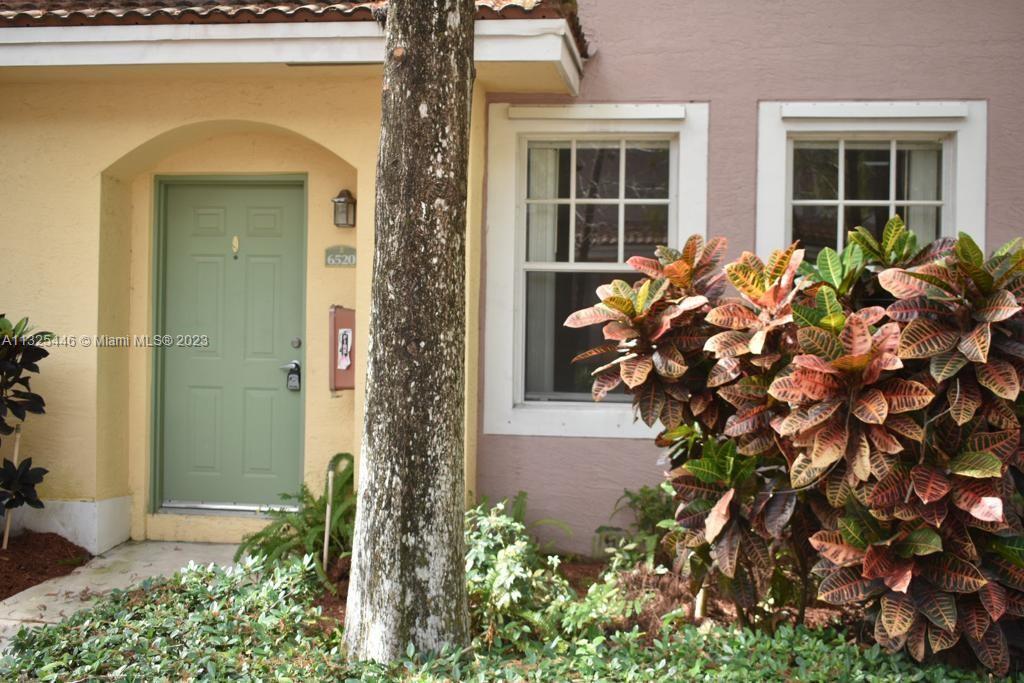 6520 West Sample Road, Unit 6520 Coral Springs, FL 33067 - Photo 3 of 33 front view of a house with a blue gate
