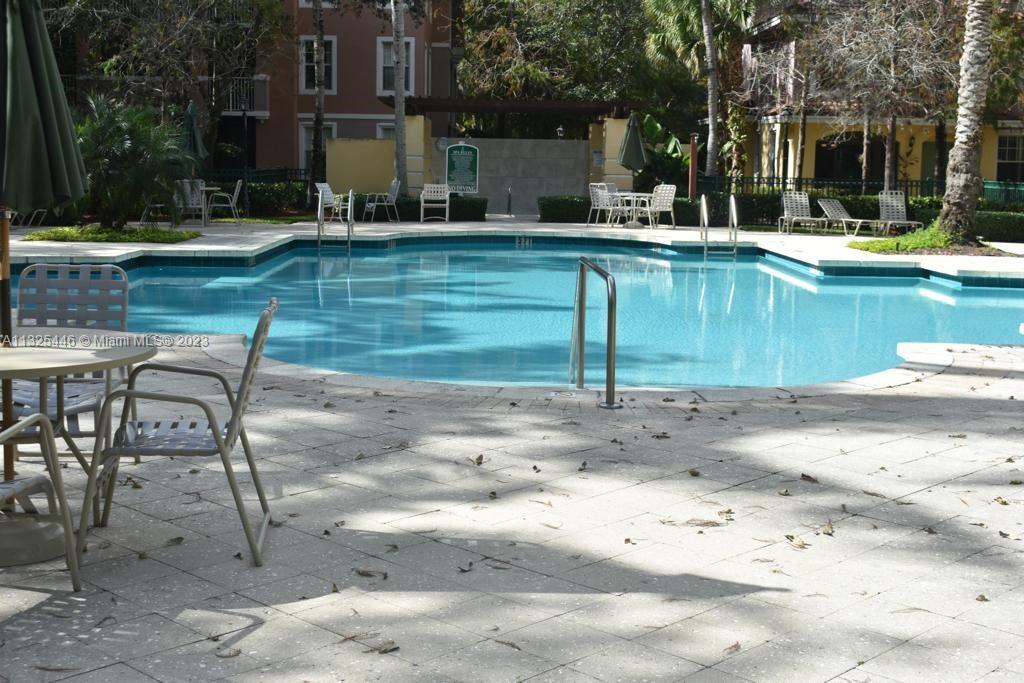 6520 West Sample Road, Unit 6520 Coral Springs, FL 33067 - Photo 31 of 33 a view of a swimming pool with outdoor seating