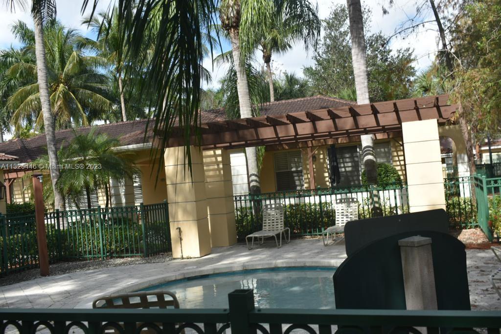 6520 West Sample Road, Unit 6520 Coral Springs, FL 33067 - Photo 32 of 33 a view of a chairs and table of a patio