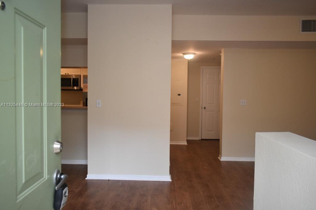 6520 West Sample Road, Unit 6520 Coral Springs, FL 33067 - Photo 4 of 33 a view of empty room with wooden floor