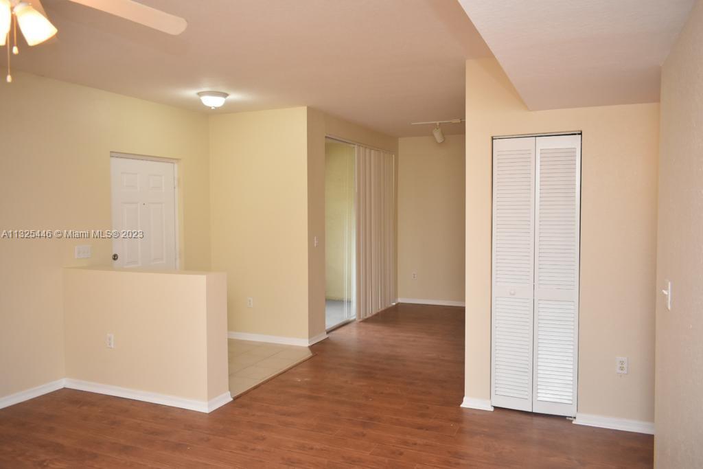 6520 West Sample Road, Unit 6520 Coral Springs, FL 33067 - Photo 6 of 33 an empty room with wooden floor