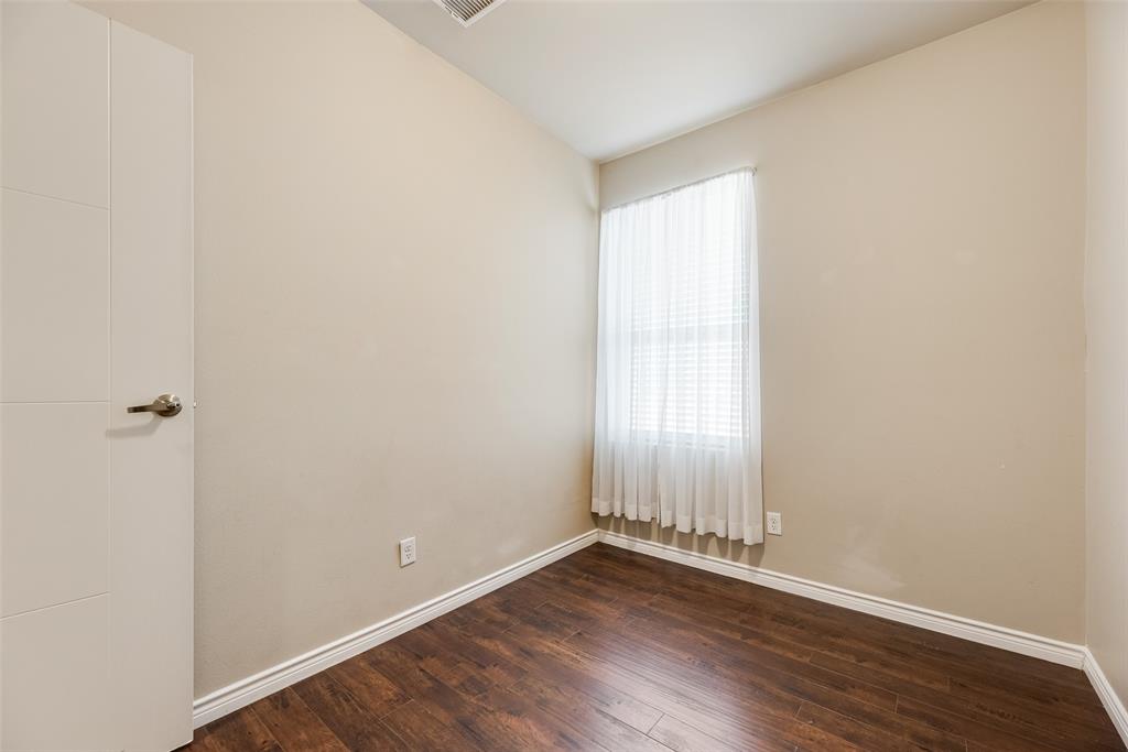 1100 West Trinity Mills Road, Unit 2040 Carrollton, TX 75006 - Photo 19 of 21 an empty room with wooden floor and windows