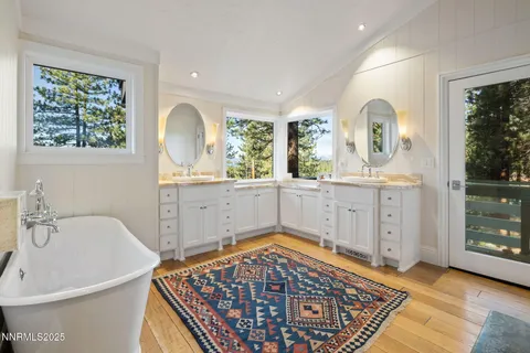 a bathroom with a bathtub sink and mirror
