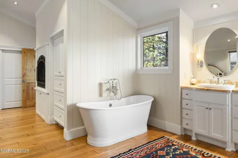 a white bath tub sitting next to a bathroom sink