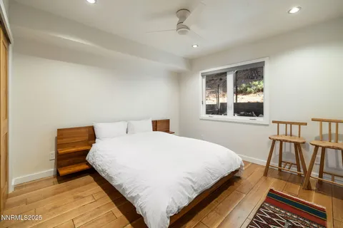 a bedroom with a bed a dresser and a book shelf