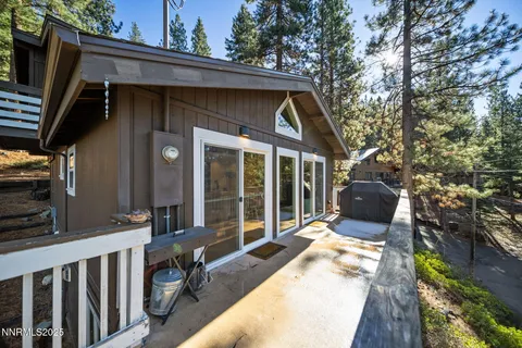 a view of house with backyard outdoor seating and hardwood floor