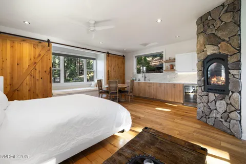 a bedroom with a bed and a flat tv screen on the dresser