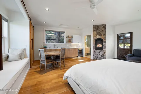 a spacious bedroom with a large bed and a wooden floor