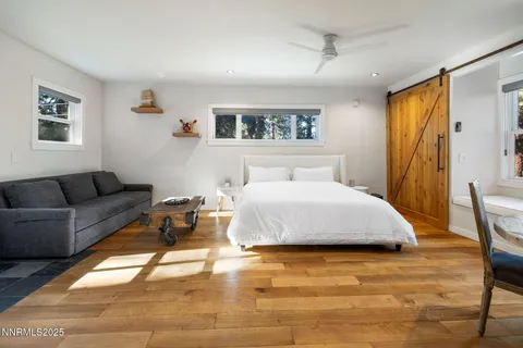 a bedroom with a bed couch and a window