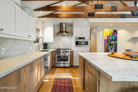 a kitchen with stainless steel appliances granite countertop a sink and cabinets