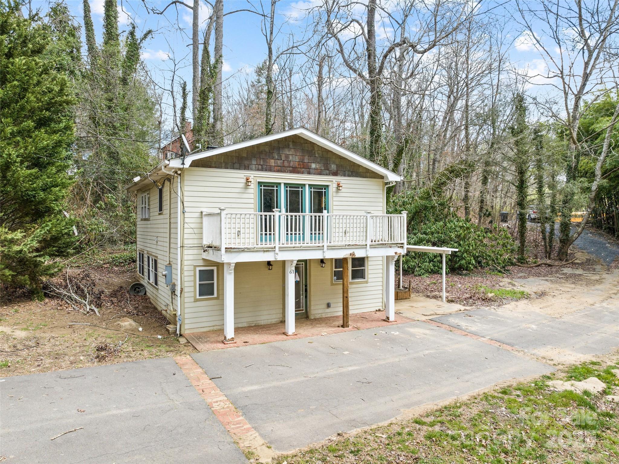 61 Riverbend Street Canton, NC 28716 - Photo 6 of 24 a front view of a house with a yard and garage