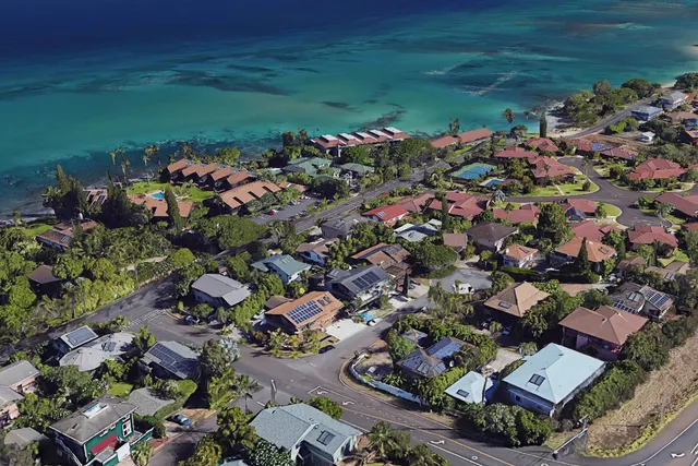 an aerial view of a houses with a yard