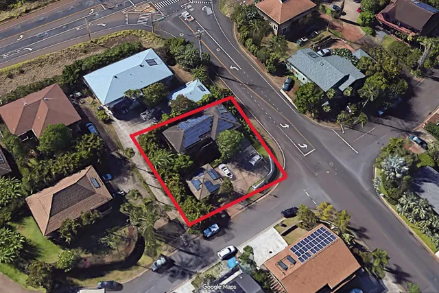 an aerial view of a residential houses with yard
