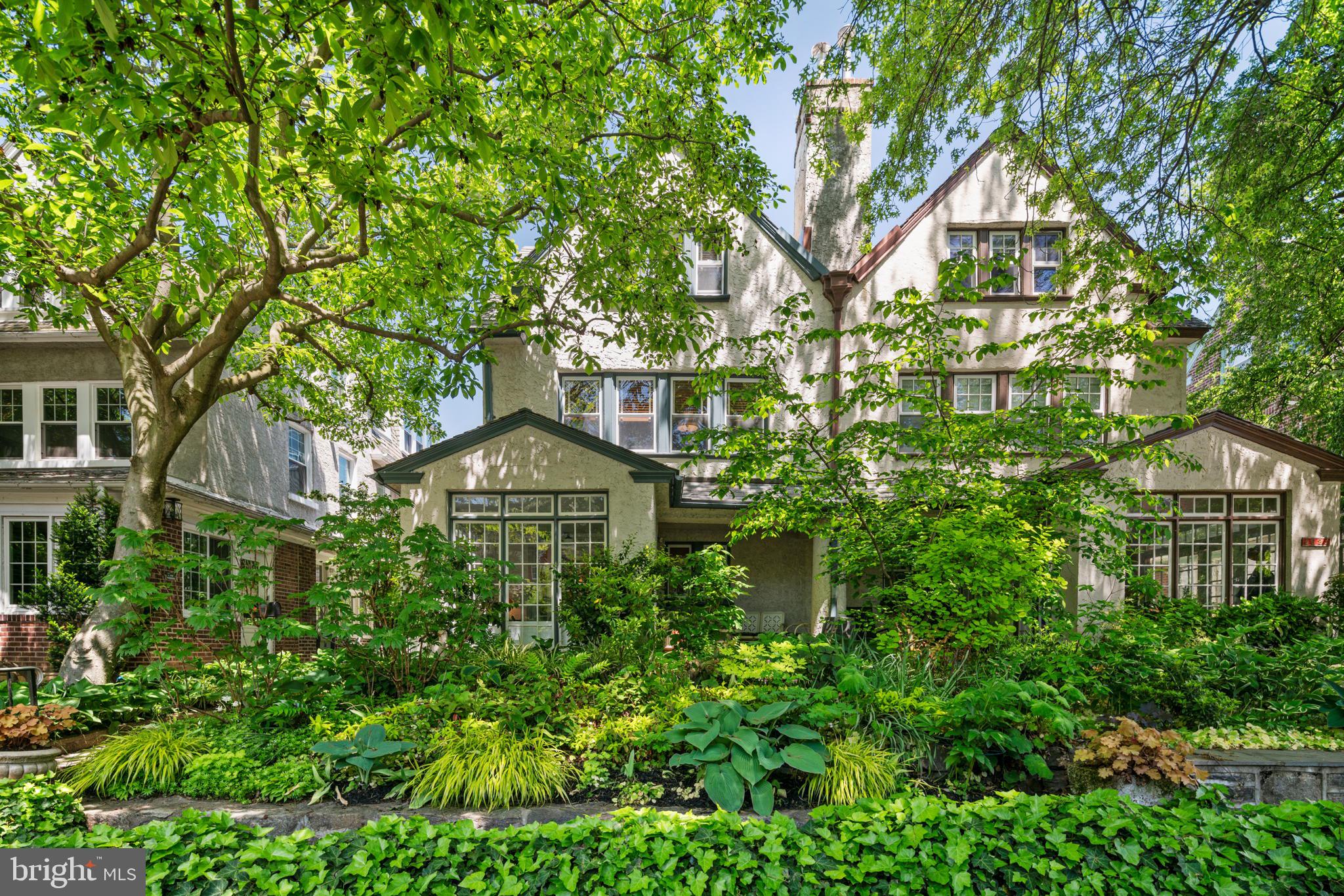 a view of a large trees in front of a house