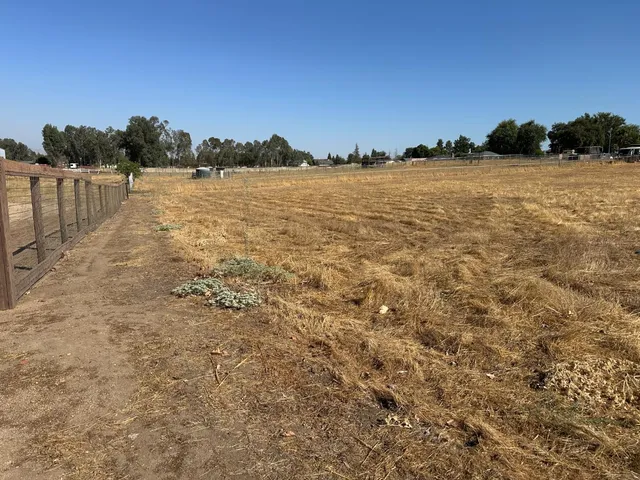 a view of a lake with green field