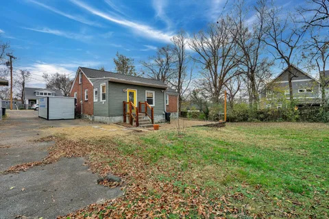 a view of a house with a backyard