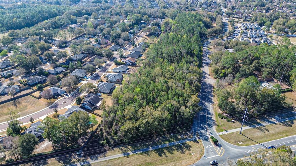 8717 Southwest Archer Road Gainesville, FL 32608 - Photo 2 of 26 an aerial view of residential houses with outdoor space and trees