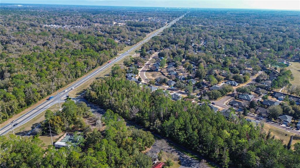 8717 Southwest Archer Road Gainesville, FL 32608 - Photo 7 of 26 a view of a city from a balcony with a lush green forest