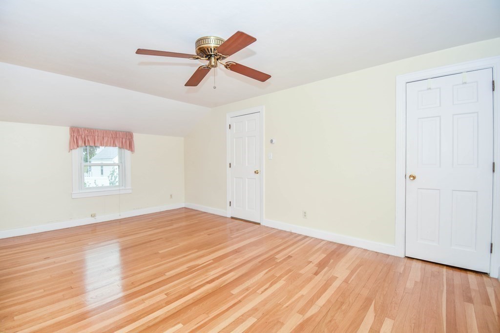 34 Farnum Road Waltham, MA 02453 - Photo 16 of 29 an empty room with wooden floor ceiling fan and windows
