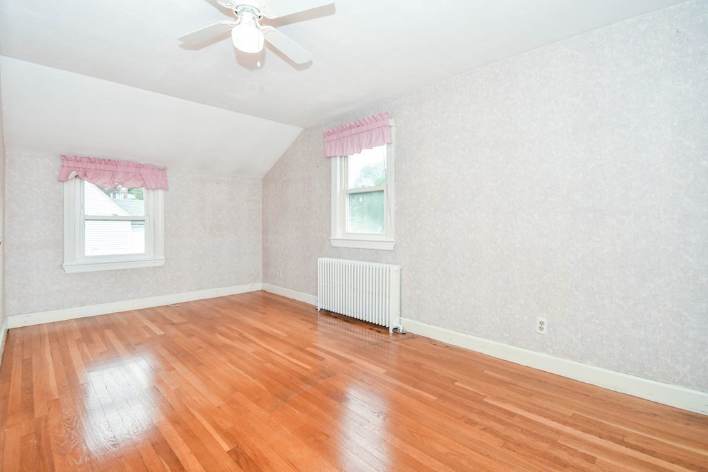 34 Farnum Road Waltham, MA 02453 - Photo 18 of 29 an empty room with wooden floor fan and windows