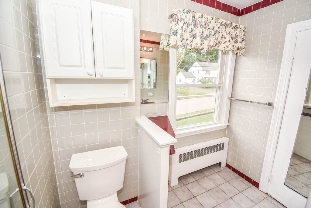 34 Farnum Road Waltham, MA 02453 - Photo 19 of 29 a bathroom with a toilet and a shower curtain