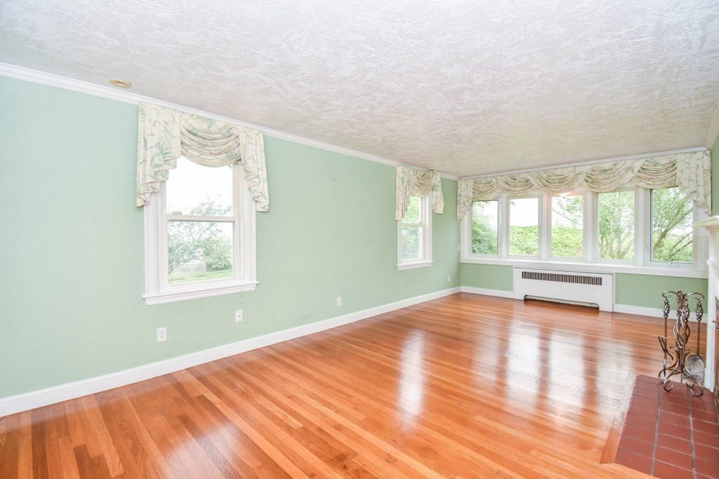 34 Farnum Road Waltham, MA 02453 - Photo 4 of 29 an empty room with wooden floor and windows