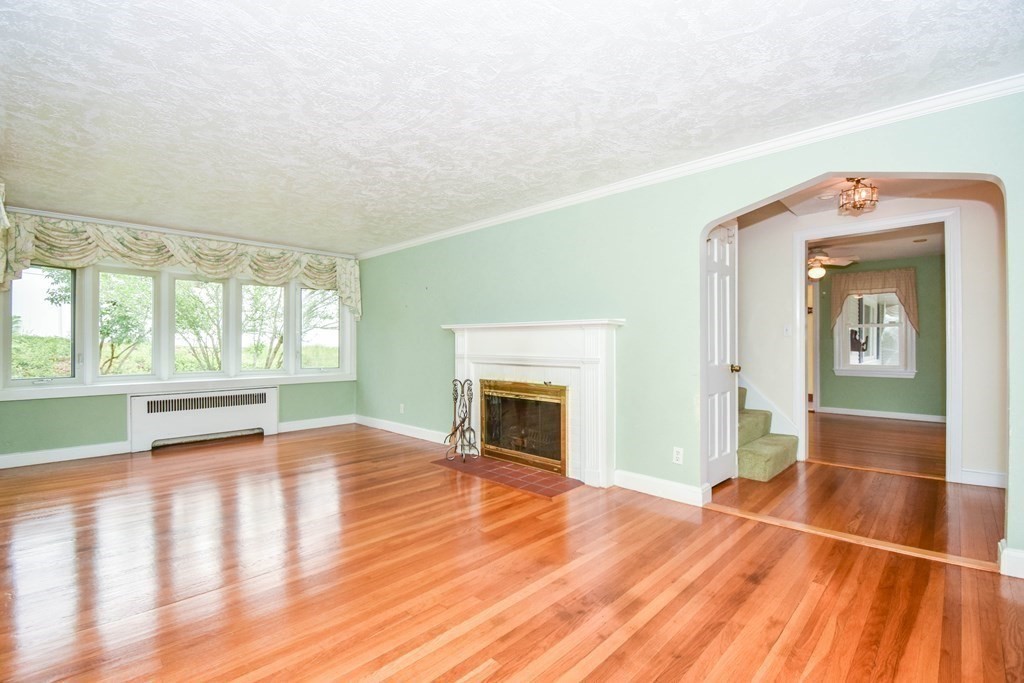 34 Farnum Road Waltham, MA 02453 - Photo 5 of 29 a view of an empty room with window and wooden floor
