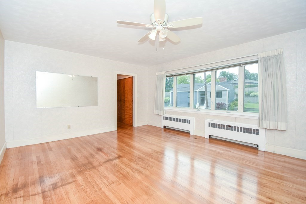 34 Farnum Road Waltham, MA 02453 - Photo 7 of 29 an empty room with windows and ceiling fan