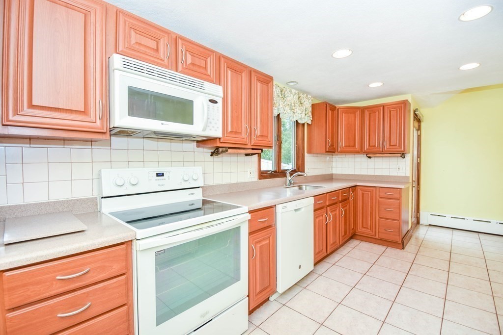 34 Farnum Road Waltham, MA 02453 - Photo 10 of 29 a kitchen with stainless steel appliances granite countertop a sink and a stove top oven