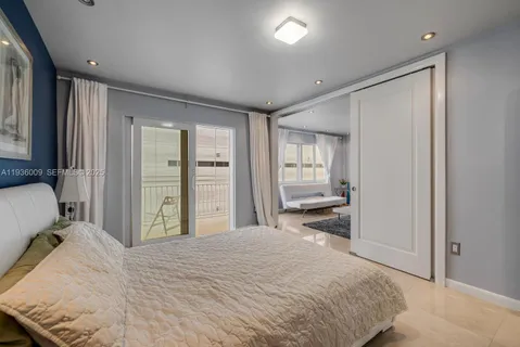 a bedroom with a bed and a large mirror