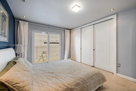 a bedroom with a bed and cabinets