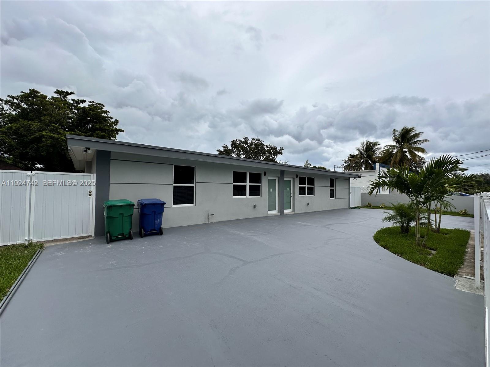 view of a house with a yard and a car parked
