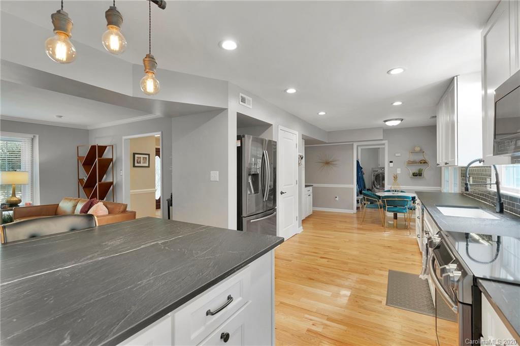 7101 Graburn Road Charlotte, NC 28226 - Photo 13 of 25 a view of a kitchen with kitchen island a sink stainless steel appliances and living room view