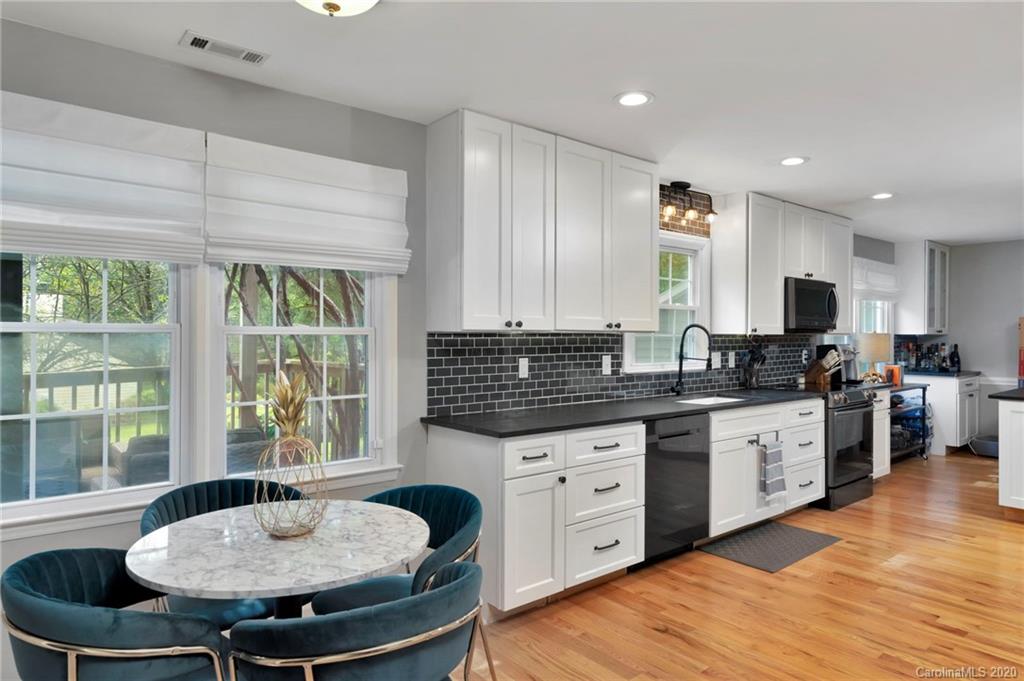 7101 Graburn Road Charlotte, NC 28226 - Photo 15 of 25 a kitchen with stainless steel appliances granite countertop a stove a sink and a refrigerator