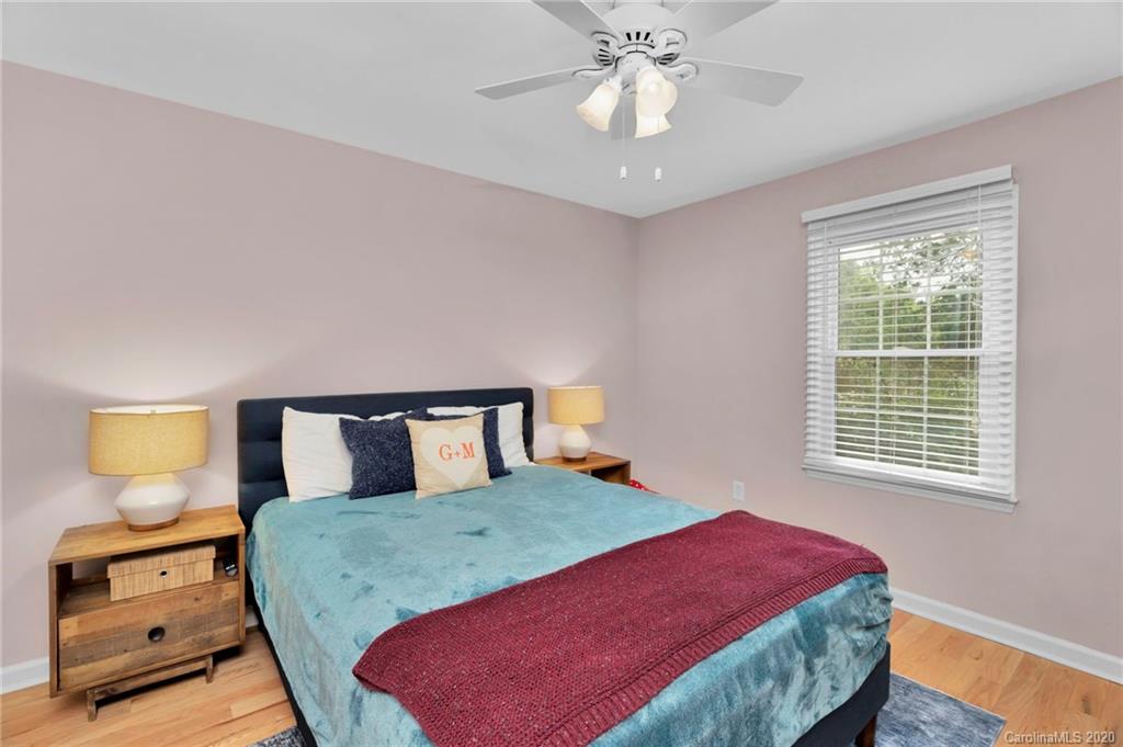 7101 Graburn Road Charlotte, NC 28226 - Photo 19 of 25 a bedroom with a bed and wooden floor