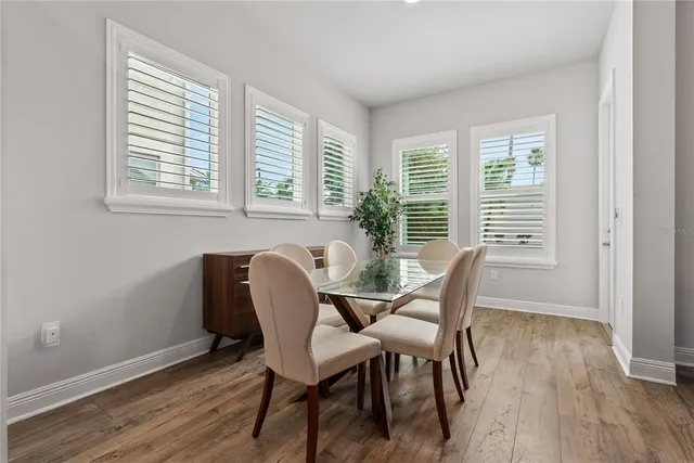 a view of a dining room with furniture and windows