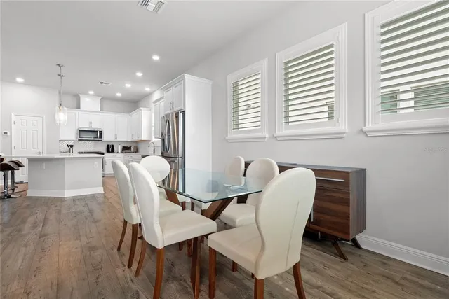 a dining room with furniture and wooden floor