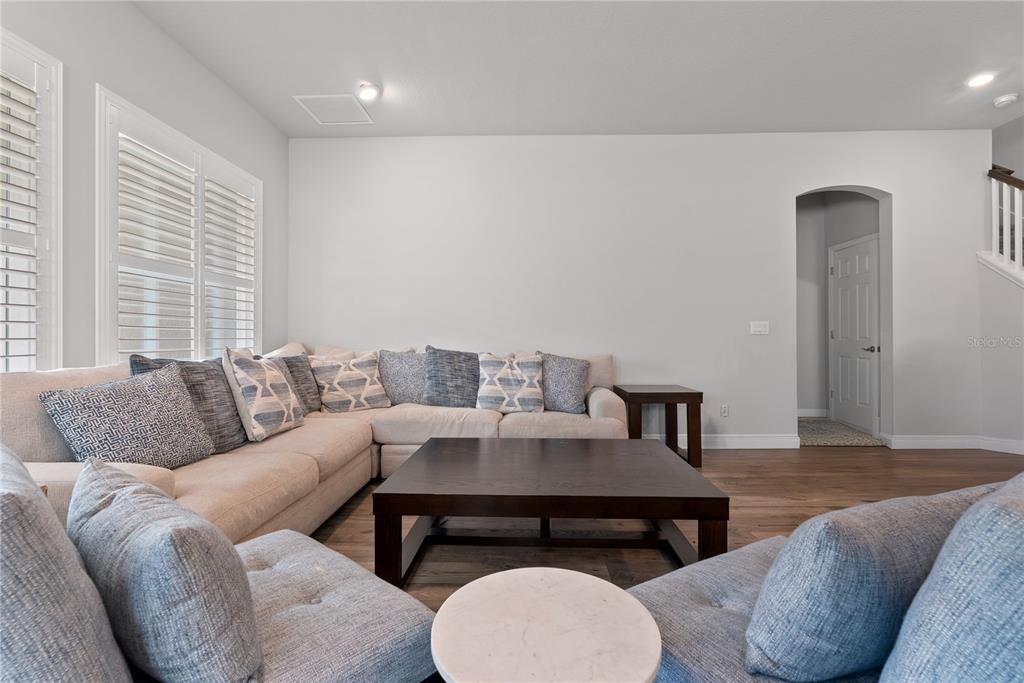 16409 Lucia Gardens Lane Tampa, FL 33625 - Photo 18 of 48 a living room with furniture and a wooden floor