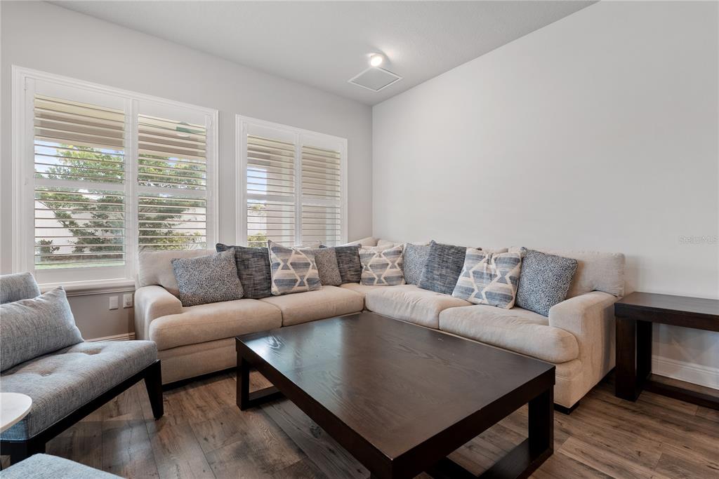 16409 Lucia Gardens Lane Tampa, FL 33625 - Photo 19 of 48 a living room with furniture and a large window