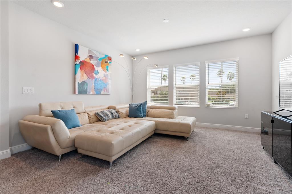 16409 Lucia Gardens Lane Tampa, FL 33625 - Photo 20 of 48 a living room with furniture and large window