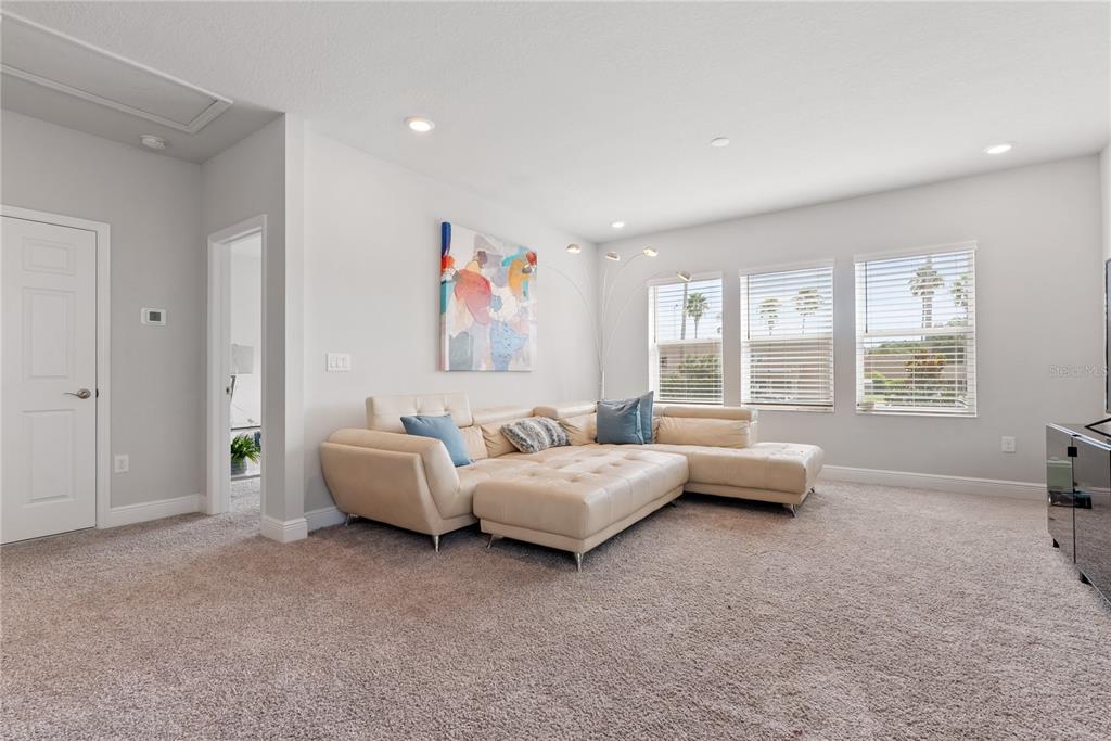 16409 Lucia Gardens Lane Tampa, FL 33625 - Photo 21 of 48 a living room with furniture and a large window