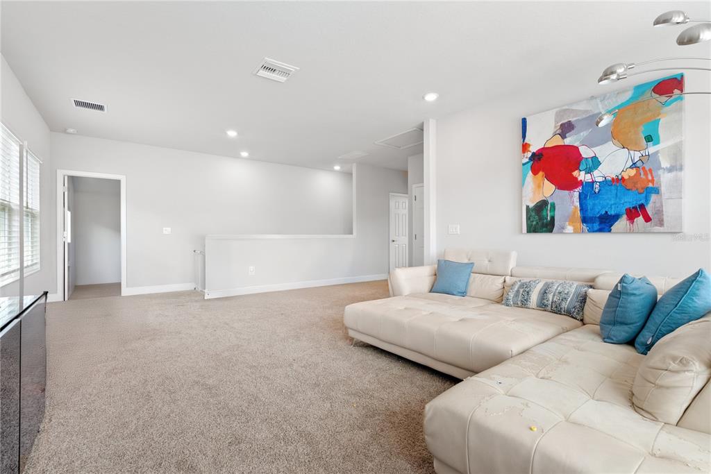 16409 Lucia Gardens Lane Tampa, FL 33625 - Photo 23 of 48 a spacious bedroom with two beds and painting on the wall