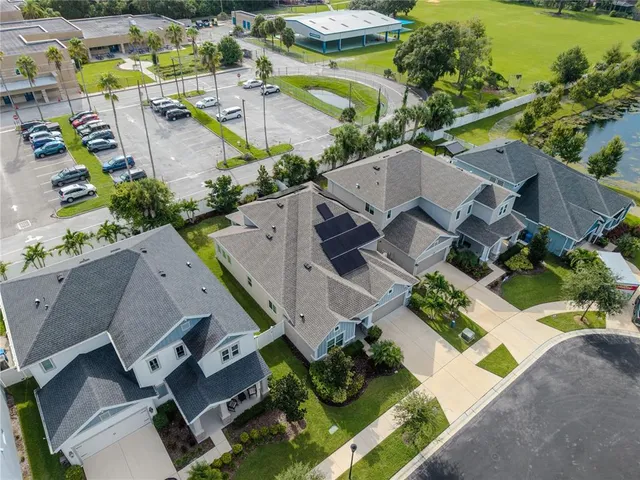 an aerial view of a house with a yard swimming pool and outdoor seating