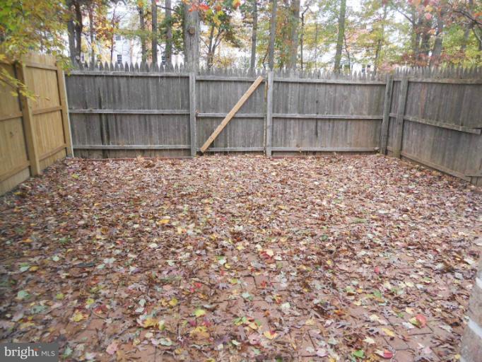 3034 Choctaw Ridge Court Woodbridge, VA 22192 - Photo 8 of 18 a view of backyard with wooden fence and a tree