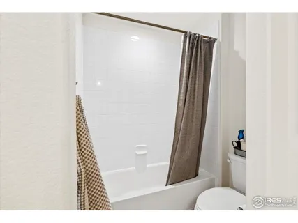 a bed room with a bed a couch and a window