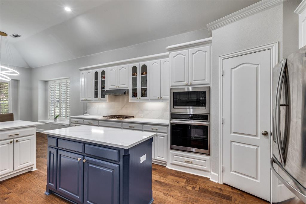 5809 Rathbone Drive Parker, TX 75002 - Photo 13 of 36 a kitchen with stainless steel appliances granite countertop a stove and a refrigerator