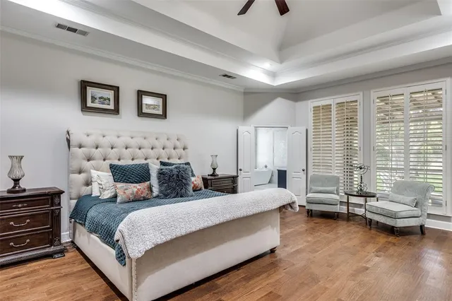 a bedroom with bed couch and window