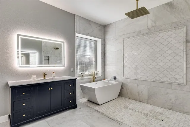 a spacious bathroom with a double vanity sink mirror and bathtub