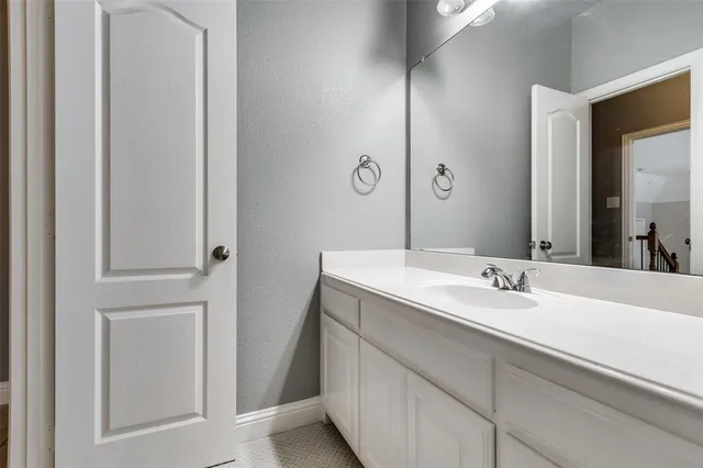 a bathroom with a double vanity sink and a mirror