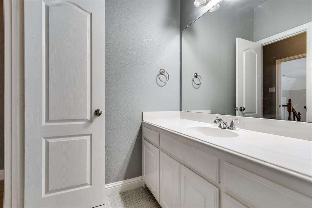 5809 Rathbone Drive Parker, TX 75002 - Photo 21 of 36 a bathroom with a double vanity sink and a mirror